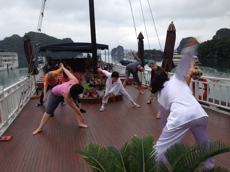 Guests do Tai Chi on board boat in Vietnam