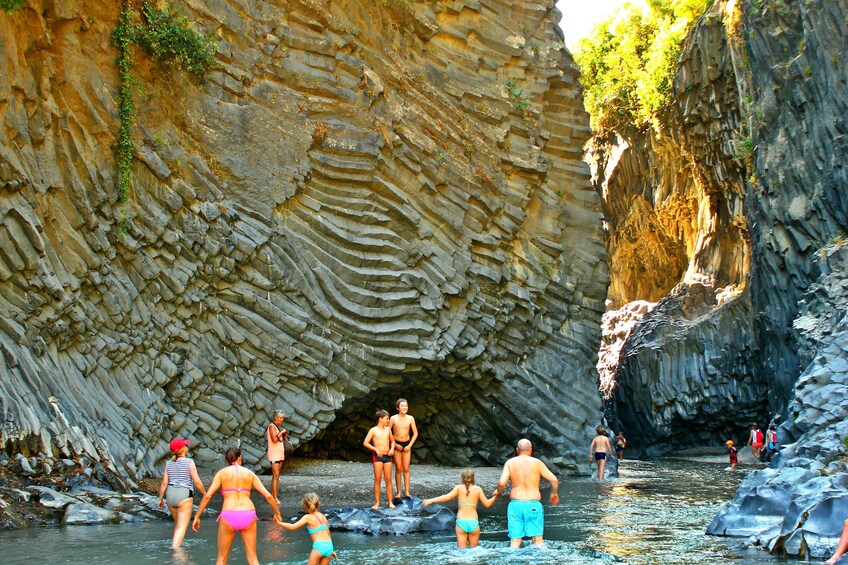 People swimming in a river in Etna