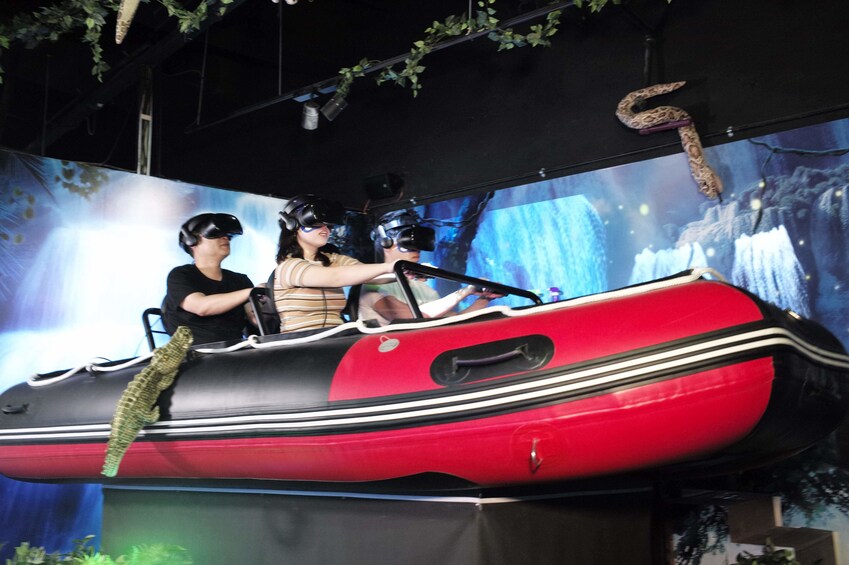 People sit on raft with VR headsets