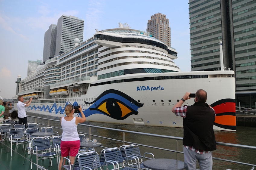 Tourists taking a photo of the AIDAperla ship on the  Rotterdam Harbour 