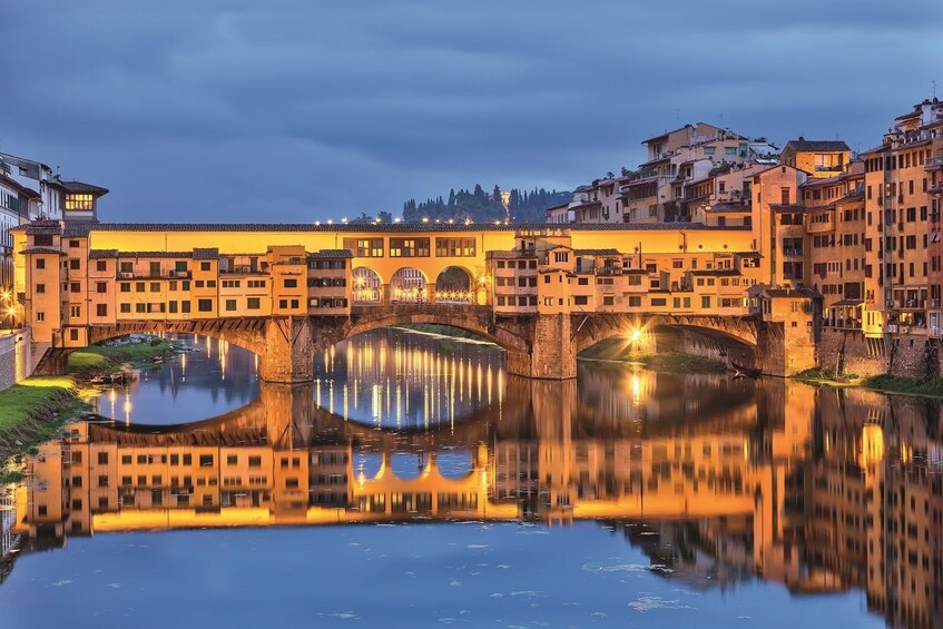 The Ponte Vecchio over River Arno in Florence, Italy at night