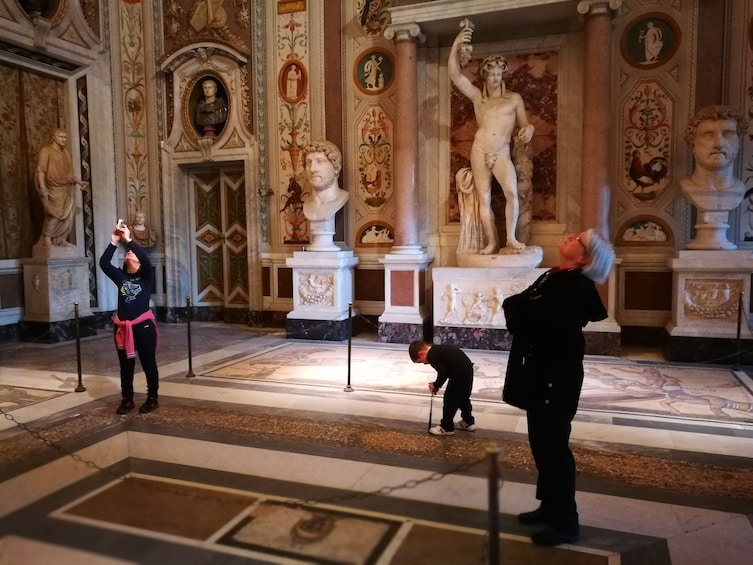 Tourists admire the interior of the Borghese Gallery in Rome, Italy