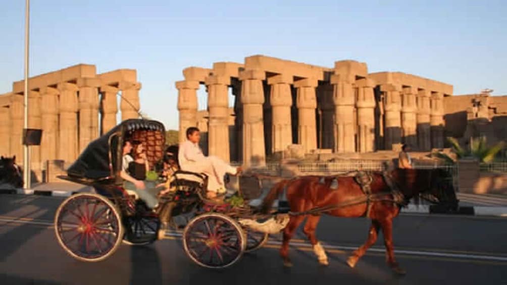 Carriage driving past columns at Luxor Temple