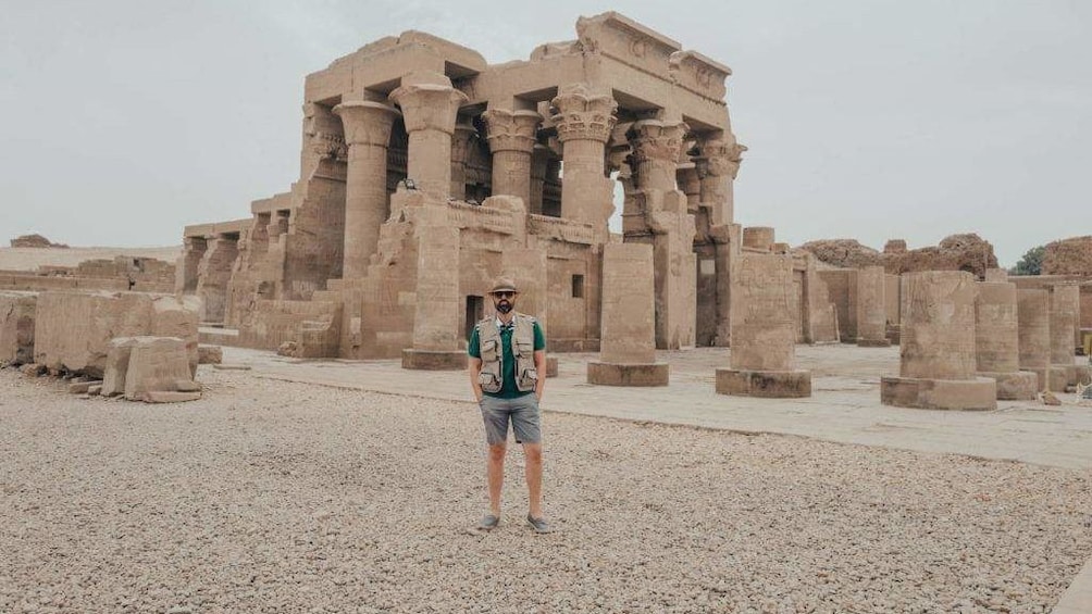 Man poses in front of Temple of Kom Ombo