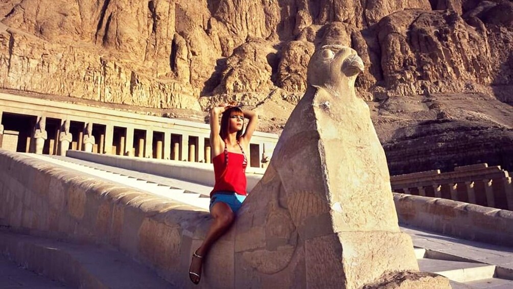 Woman poses in front of Mortuary Temple of Hatshepsut