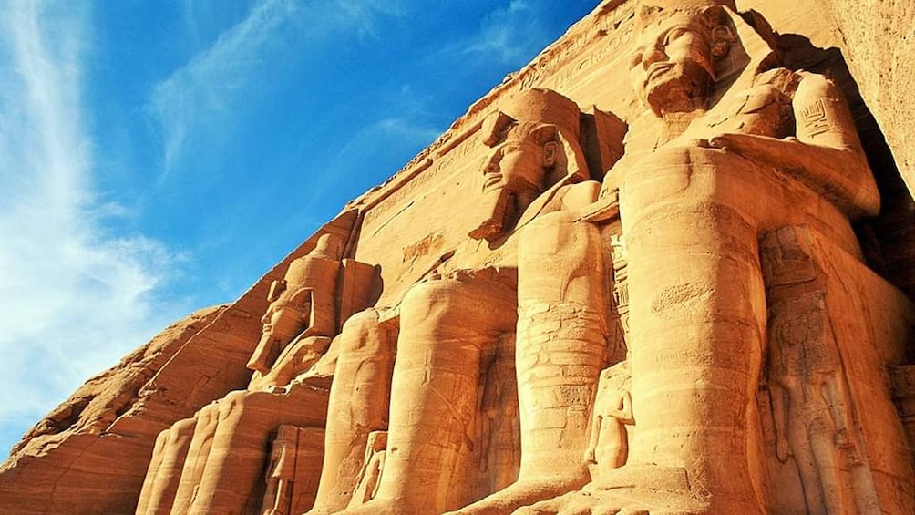 View from the ground of large statues carved into Abu Simbel Temples in Aswan, Egypt