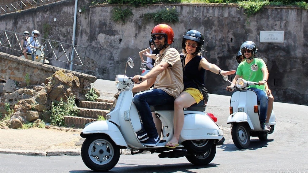 People riding scooters in Tuscany