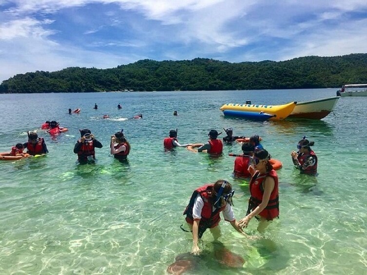 Group snorkeling at Usukan Cove
