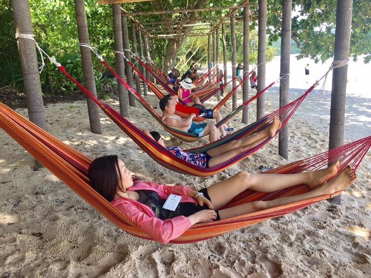 Group relaxing on hammocks on Pandan Pandan Island

