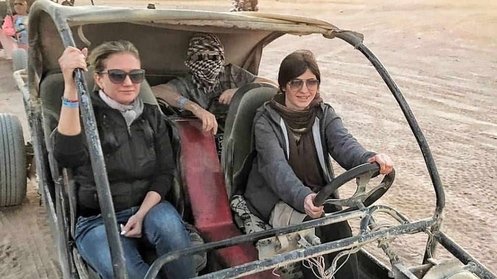 Closeup of tourists in dune buggy in Hurghada Desert, Egypt