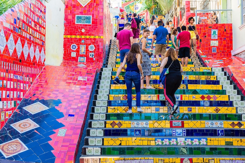 People walk up the colorful Selaron Steps in Rio de Janeiro, Brazil