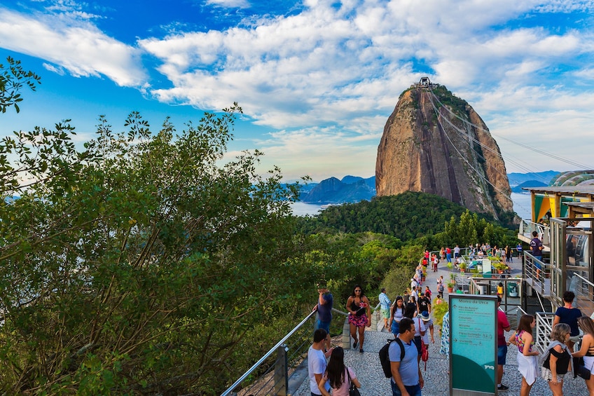 Tourists near the gondola entrance with Sugarloaf Mountain in the background