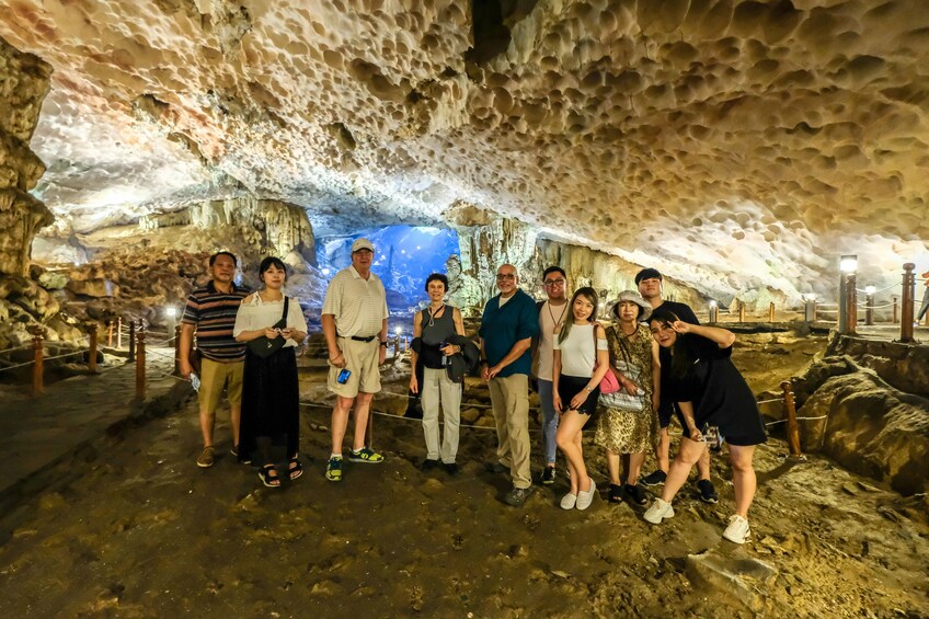 Tourists pose inside enclosed Surprising Cave off Halong Bay in Vietnam