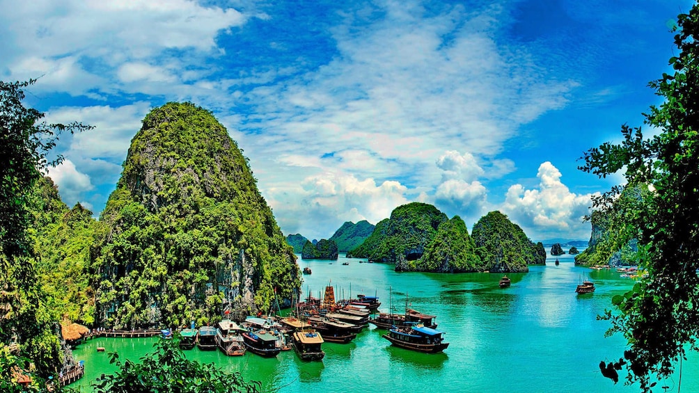 Boats docked at an island in Halong Bay with more islands in the background