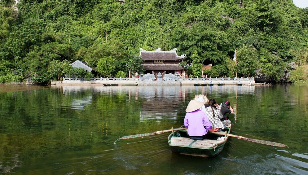Sampan boat on a river near a temple in Trang An