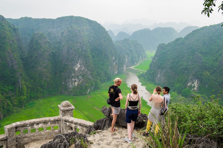 Tourists look out over Mua Caves in Ninh Binh, Vietnam