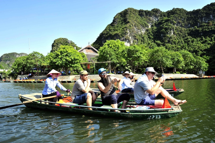 Small, crowded rowboat on Trang An River in Vietnam