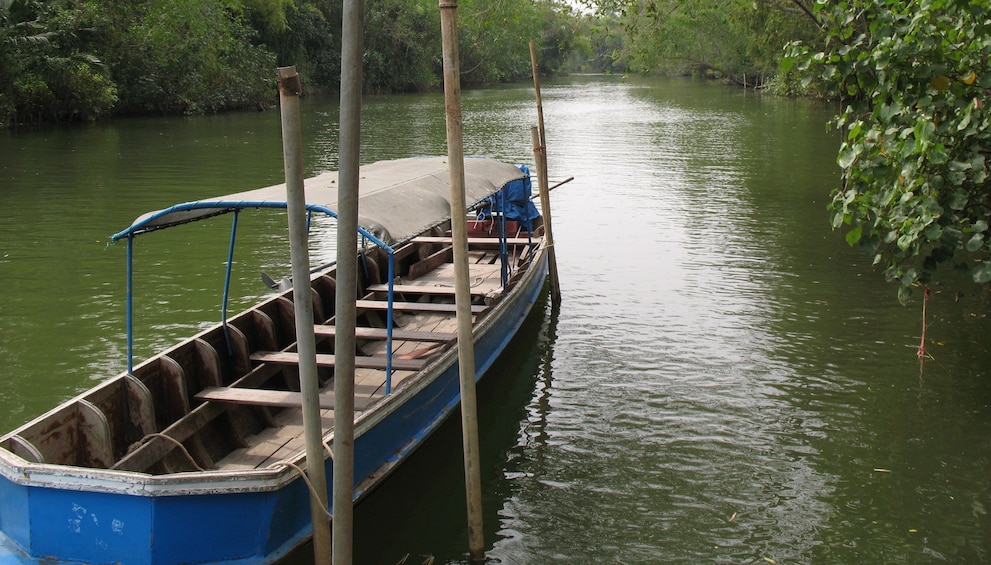 Long empty wooden boat in Pran Buri River in Thailand