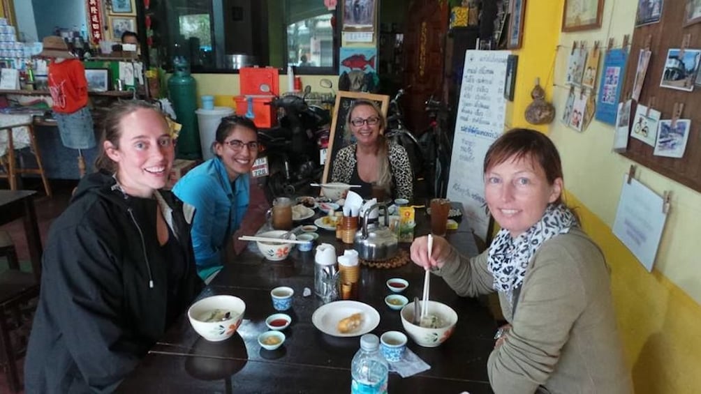 Tourists pose in cafe in Thailand 