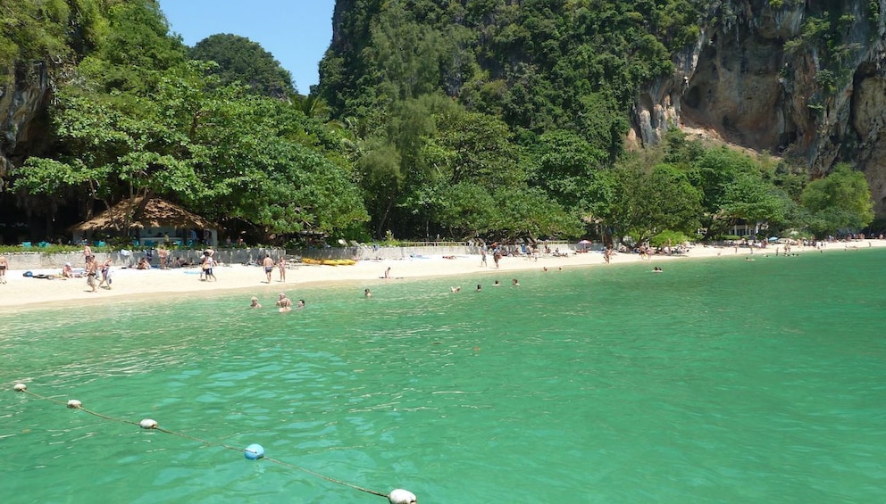 Blue green water with white sandy beach in Thailand