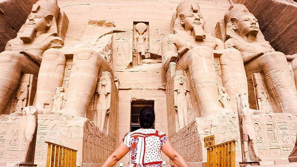 Woman poses in front of Abu Simbel Temples