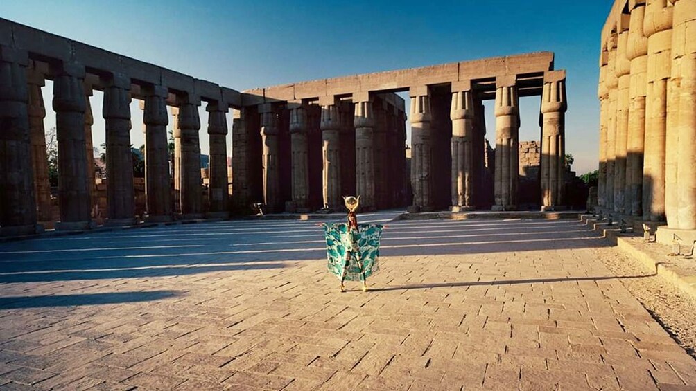 Woman poses in courtyard of Egyptian temple