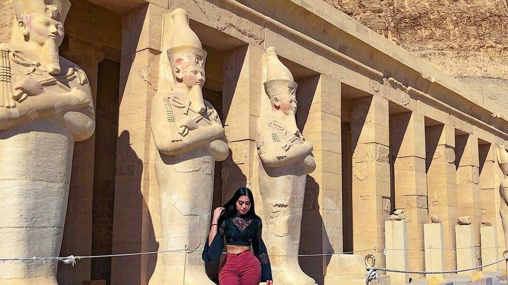 Closeup of woman posing in front of the Mortuary Temple of Hatshepsut