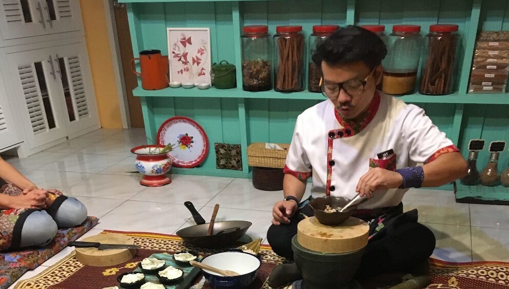 Chef speaks to guests as he tries a bite