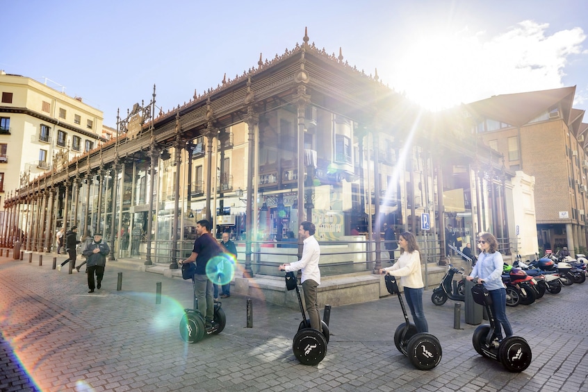 Show item 3 of 11. Segway tour group passing by San Miguel Market in Madrid, Spain