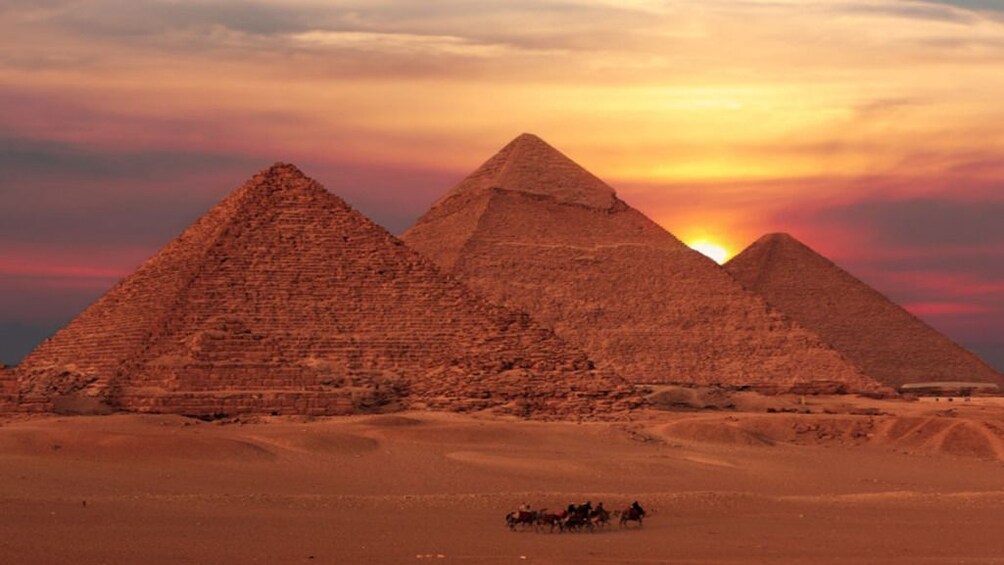 Pyramids of Giza during pink and purple sunset