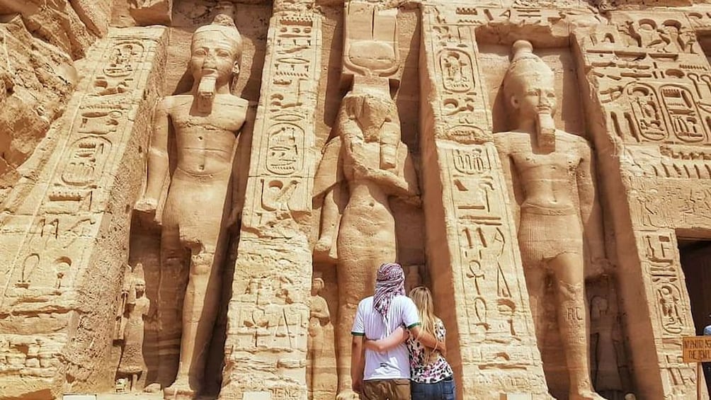 Couple look at the Abu Simbel Temples in Aswan, Egypt