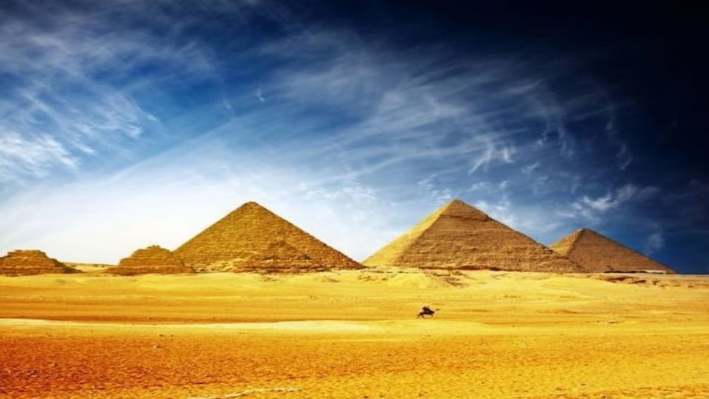 Pyramids of Giza with thin clouds above
