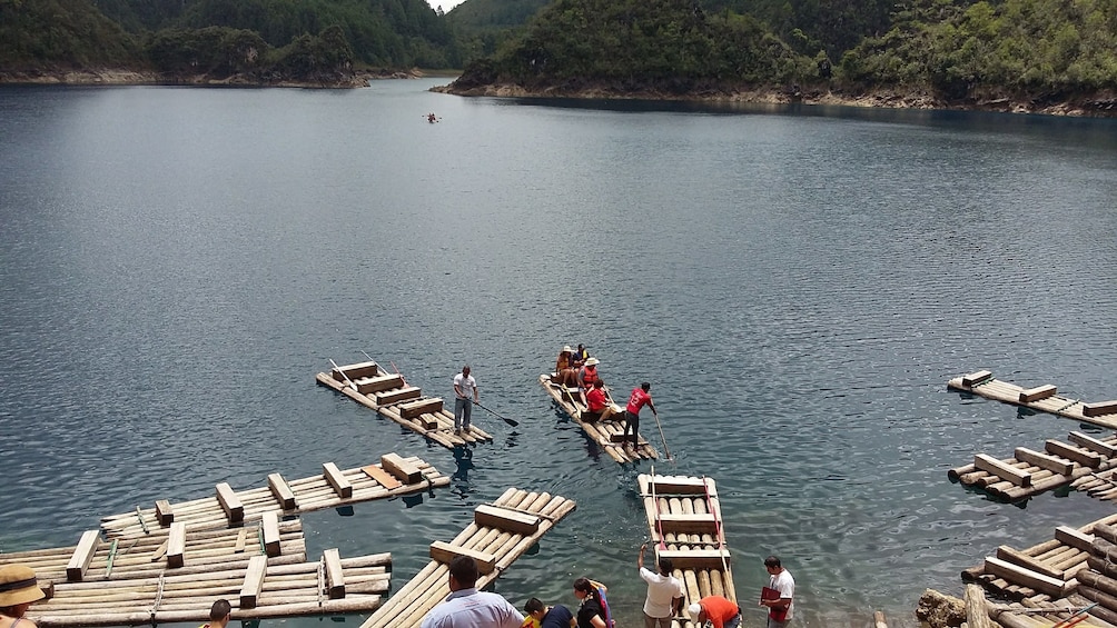 People stand on flat boats on the Montebello Lakes in Chiapas, Mexico
