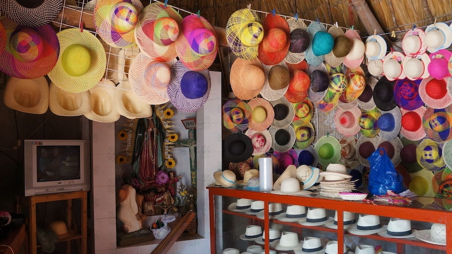 Colorful hats on walls and in display case in shop in Campeche, Mexico