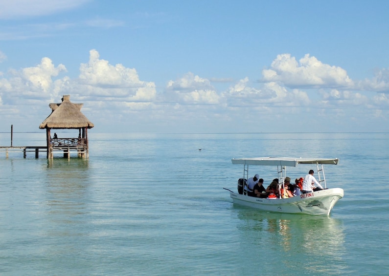 Small white boat sails towards Isla Aguada