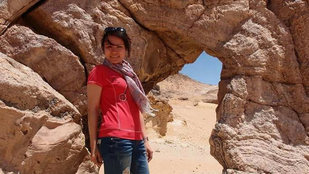 Woman poses with natural arch in Egypt