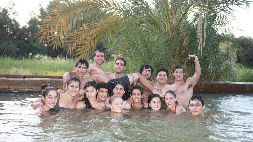 Large group of tourists pose a pool at Egyptian hotel