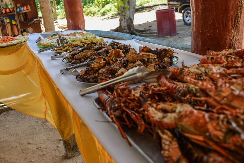 Buffet with platters of crab, chicken and vegetables