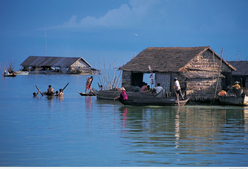 Small building surrounded by boats on Tonle Sap Lake in Angkor, Cambodia