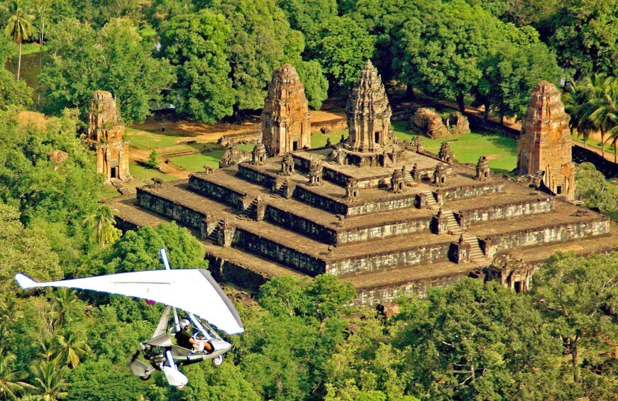Helicopter over Angkor Wat Temple Complex in Cambodia