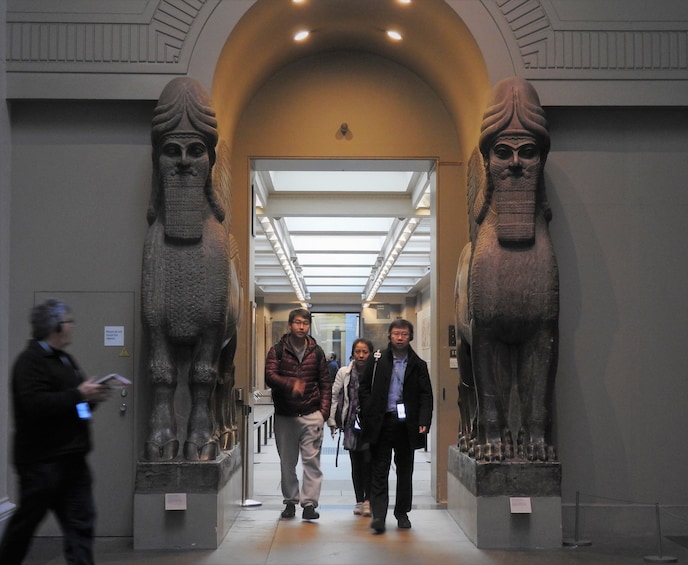 Tourists walk through hallway in the British Museum
