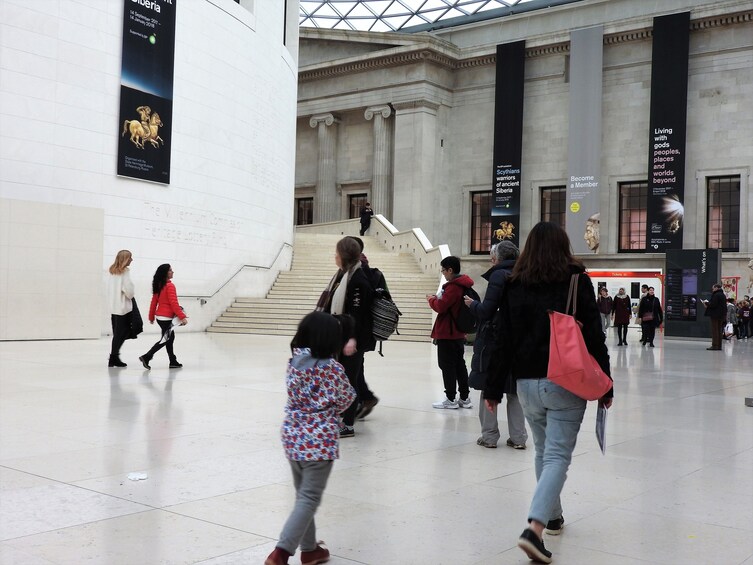 Tourists walk through British Museum in London, England
