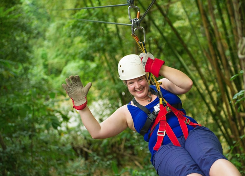 Show item 1 of 6. Woman with helmet poses on zip line in Punta Cana