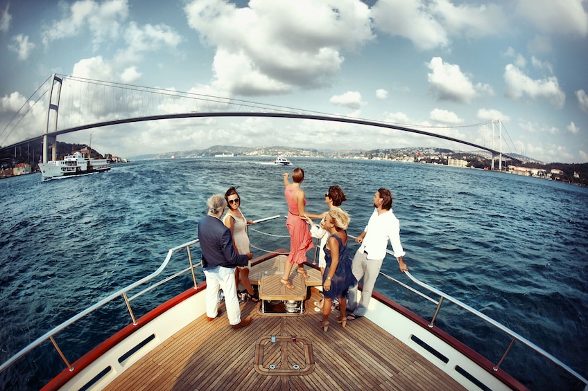 Friends at bow of boat on water in Istanbul