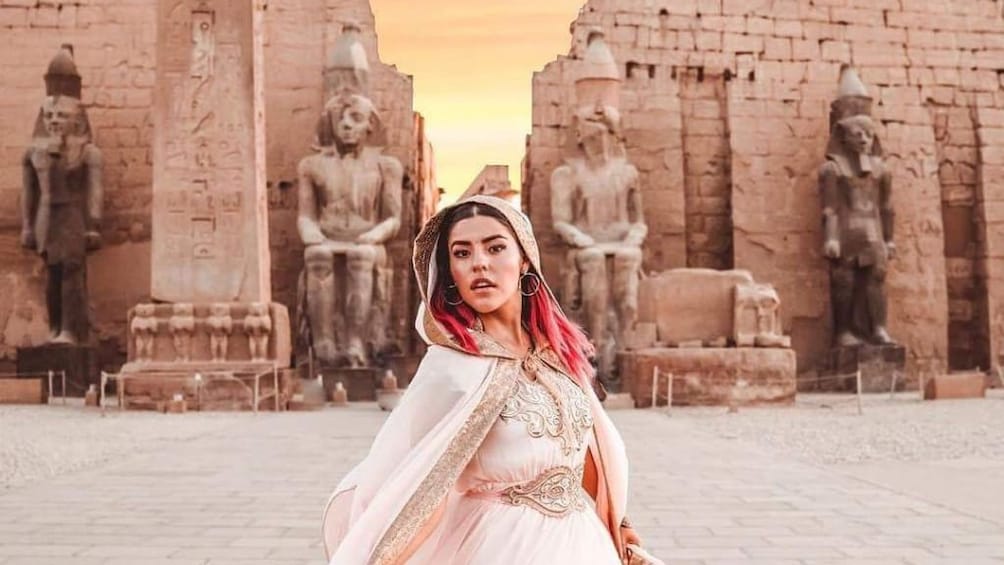 Woman spins in front of Luxor Temple at sunset