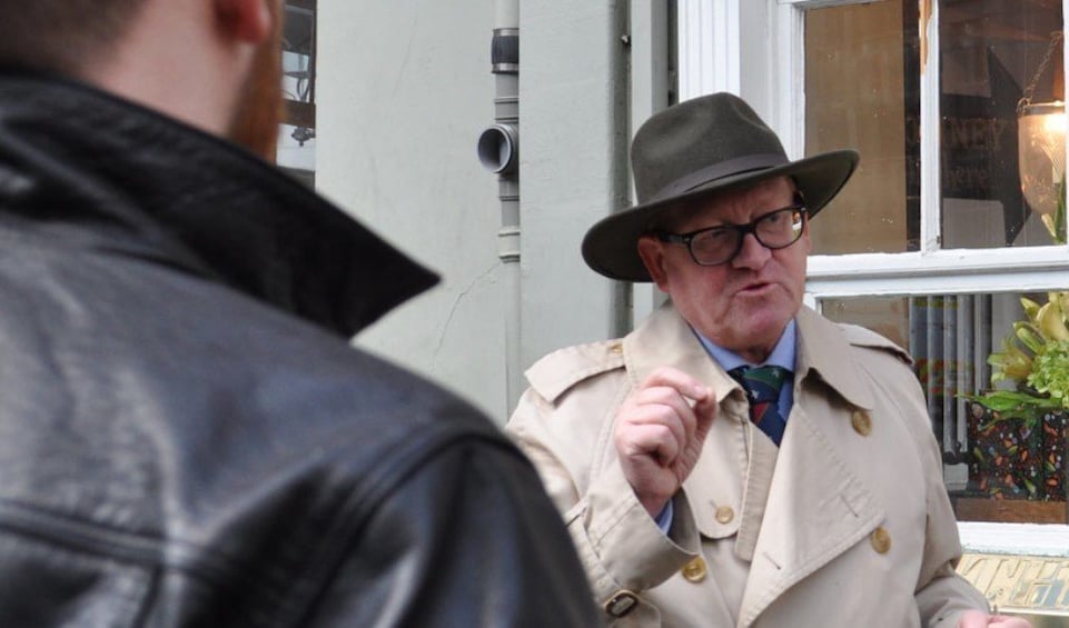 Tour guide dressed like a spy in London