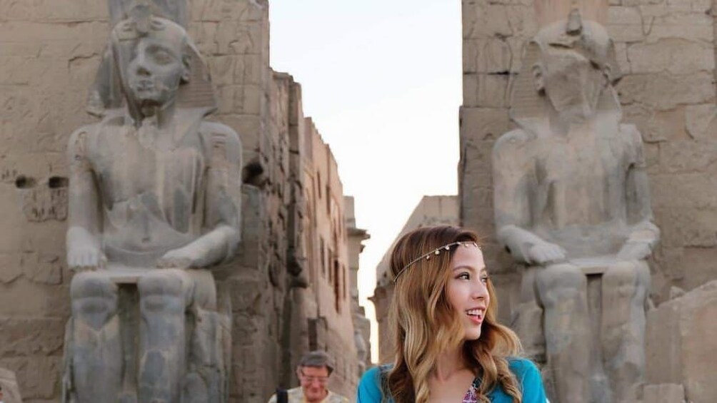 Woman poses in front of Luxor Temple in Luxor, Egypt