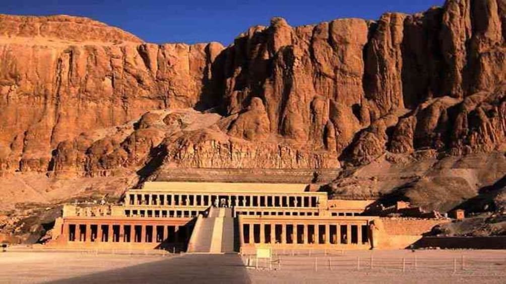 Mortuary Temple of Hatshepsut with cliffs behind it