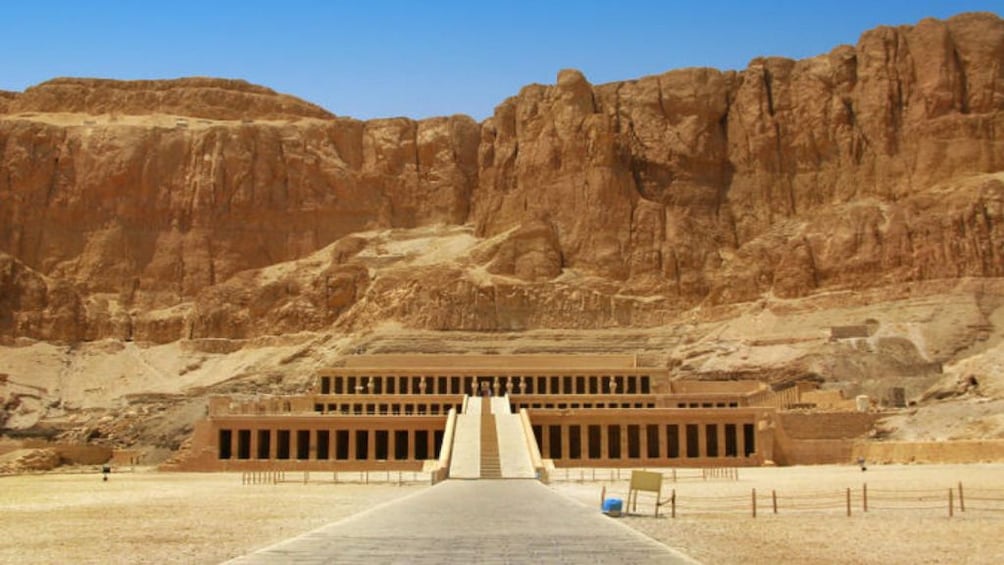 Panoramic view of Mortuary Temple of Hatshepsut with cliffs in the background