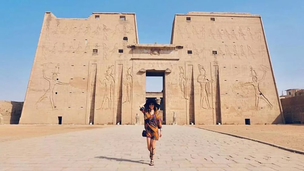 Woman in front of The Temple of Horus at Edfu in Aswan, Egypt